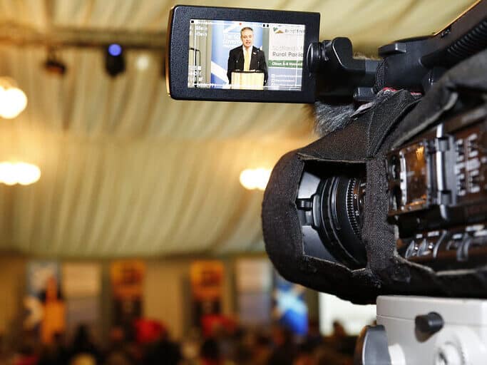 close up to a video camera recoding Richard Lochhead, Cabinet Secretary for Rural Affairs, Food and Environment, speaking at the opening of the 2014 Sottish Rural Parliament